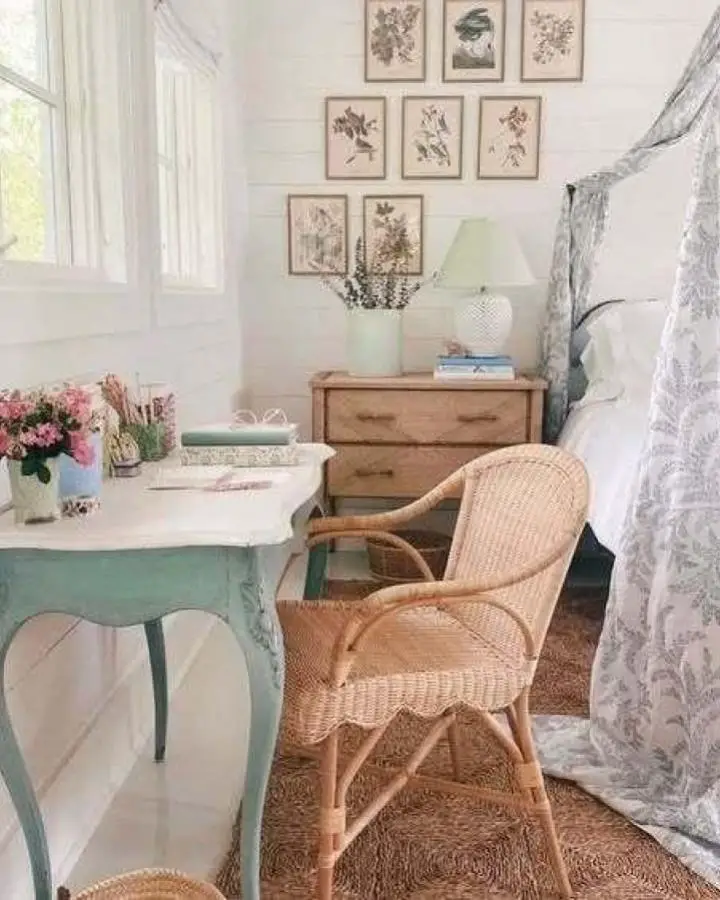 Botanical gallery wall bedroom from @joydecord. Vintage pressed flower prints with rattan chair and sage desk.