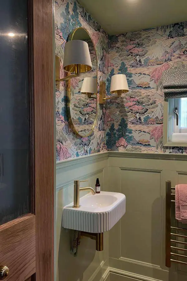 Floral wallpaper powder room from @jackdmarch showcasing cottagecore bathroom ideas with sage paneling and brass accents.