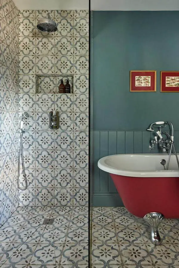 Cream floral patterned cement tiles from @johnstonparkeinteriors. Features vintage brass shower fixtures and red clawfoot bathtub.