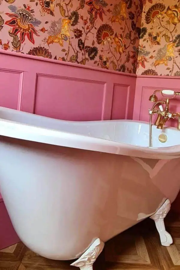 Dusty pink wainscoting bathroom from @the_tiny_townhouse. Features clawfoot tub and floral wallpaper.