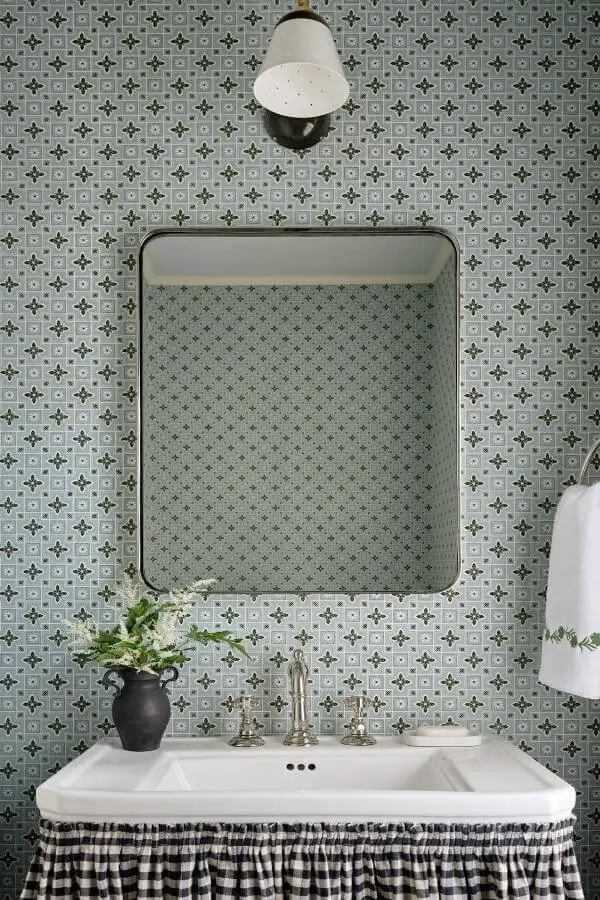 Sage green patterned wallpaper bathroom from @katierosenfeld. Features vintage mirror and natural styling elements.