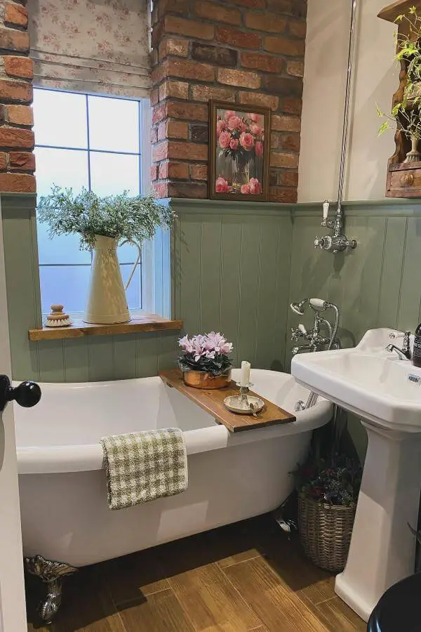 Sage green wainscoting bathroom from @janesarah1_home_and_family_. Features exposed brick, vintage fixtures and rustic decor elements.