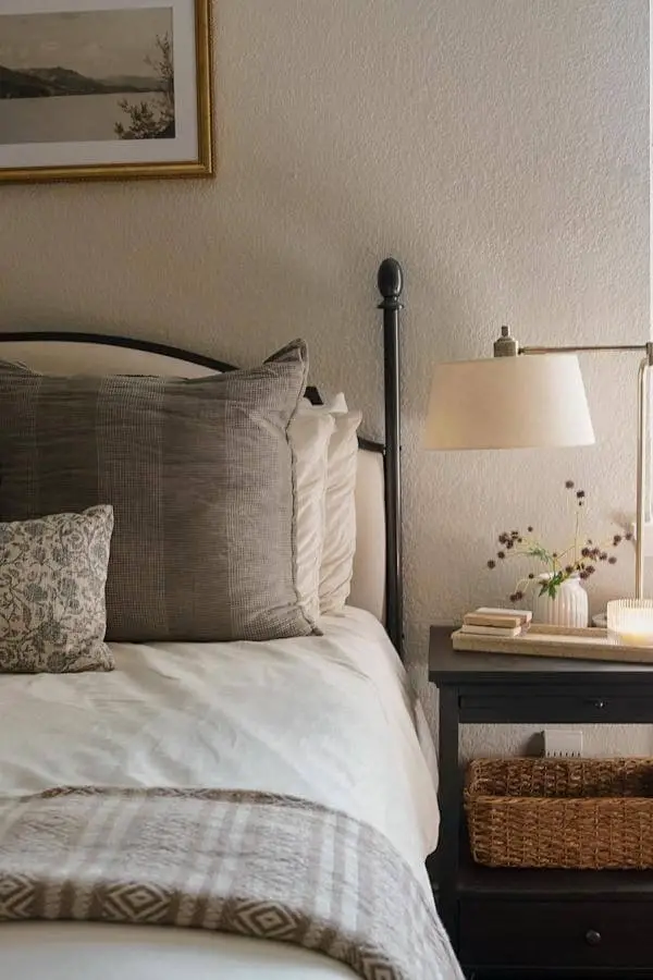 Neutral-toned chic nightstand with cozy basket storage from @shannonsantiagohome, perfect for a serene bedroom setup.