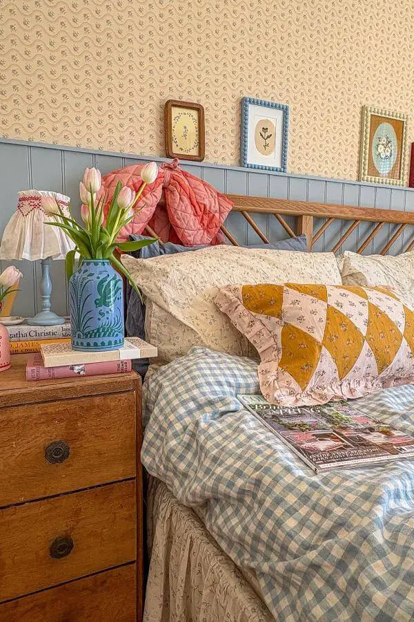 Colorful patchwork pillows add cozy charm to a cottagecore bedroom bed from @stayinginstudio. Charming focal point.
