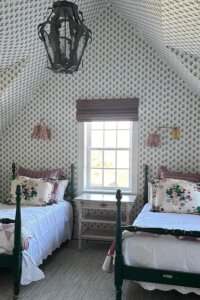 Lush allover botanical wallpaper transforms cozy attic nook from @katierosenfeld. Perfect cottagecore bedroom inspiration.