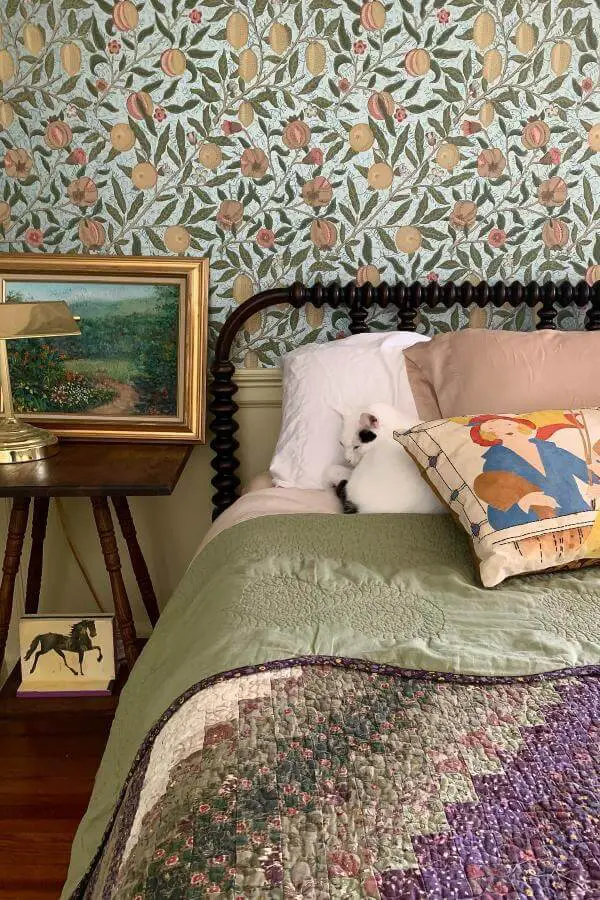 Soft pastel orchard wallpaper in bedroom from @zhuzhaus. Whimsical, cozy tone inspires cottagecore bedroom charm.