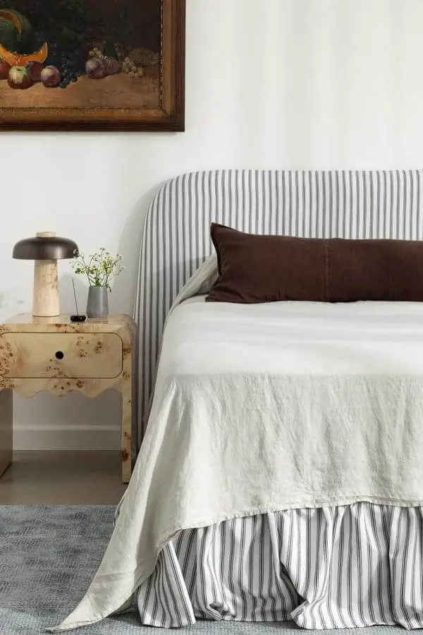 Soft striped fabric headboard from @create.estate. Adds charm and warmth to a cozy retreat space.
