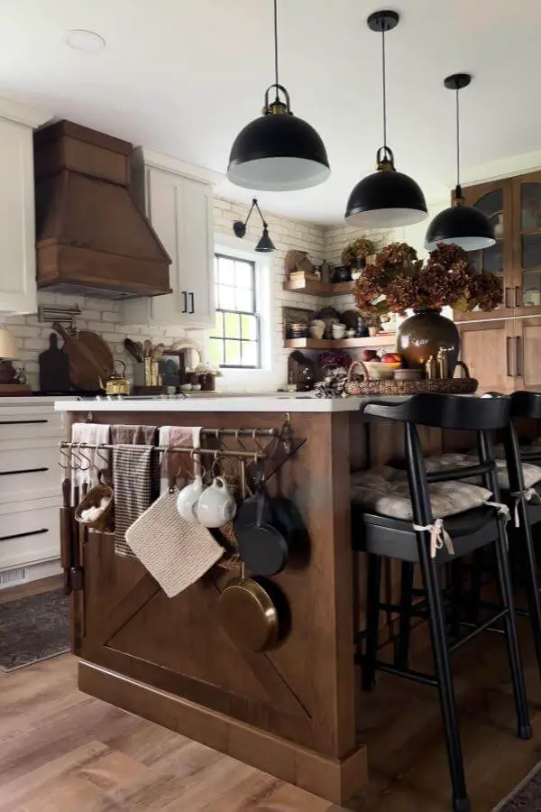 Black dome pendant lights from @theroaringcreekhome. Farmhouse kitchen with wooden island and open shelving.