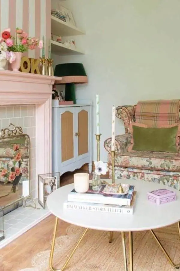 Soft pastel striped fireplace nook from @charlottejacklin. Cozy accents brighten a charming cottagecore living room.