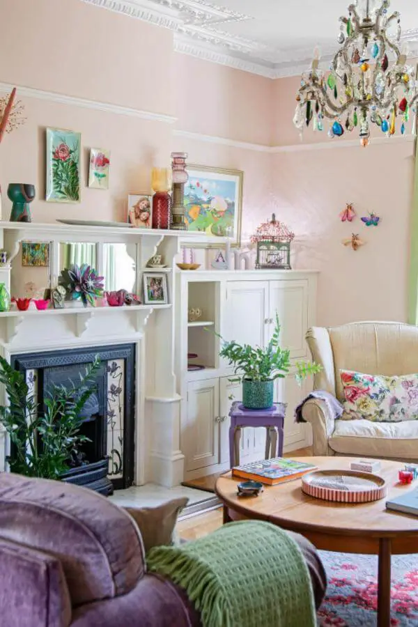 colorful vintage chandelier from @period_living. Whimsical charm enhances a cozy cottagecore living room ambiance.