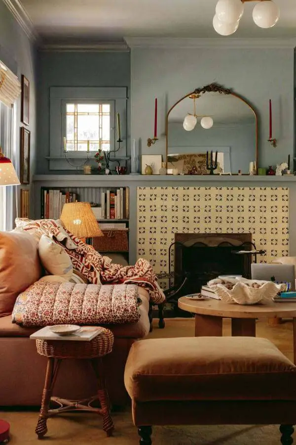 Vintage patterned fireplace mantel from @chalkwhitearrow. Cozy mantel displays inspired by cottagecore living room ideas.