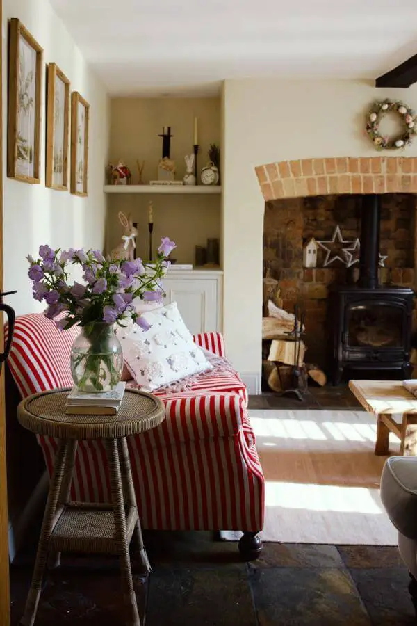 Charming red striped sofa from @athomewithbaxter. Adds playful whimsy to a cozy cottagecore living room.
