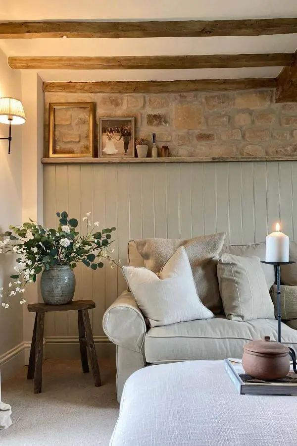 Warm stone accent wall from @life_at_the_mews. Charming rustic warmth enhances cottagecore living room vibes.