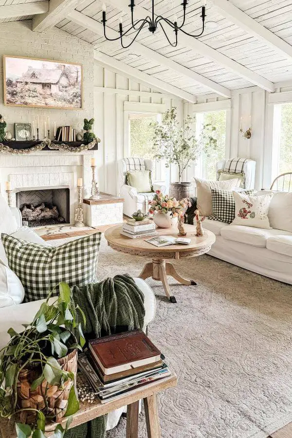 All-white paneling living room walls from @returninggrace. Airy cottage haven embodying cozy cottagecore vibes.