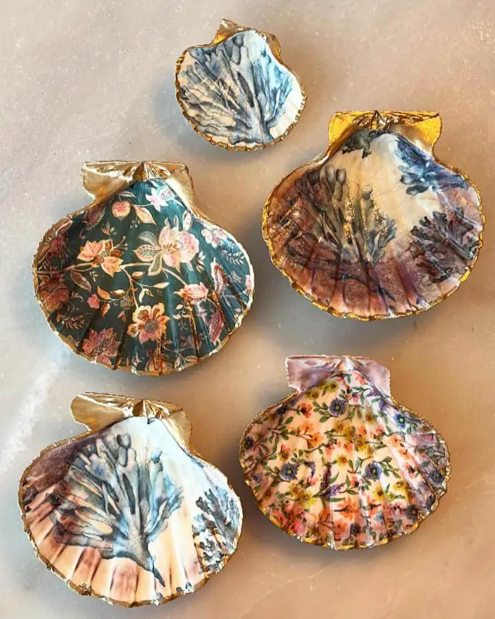 Gold-rimmed decoupage seashells from @sonoran_watercolors featuring botanical and floral craft ideas for adults with metallic edges.