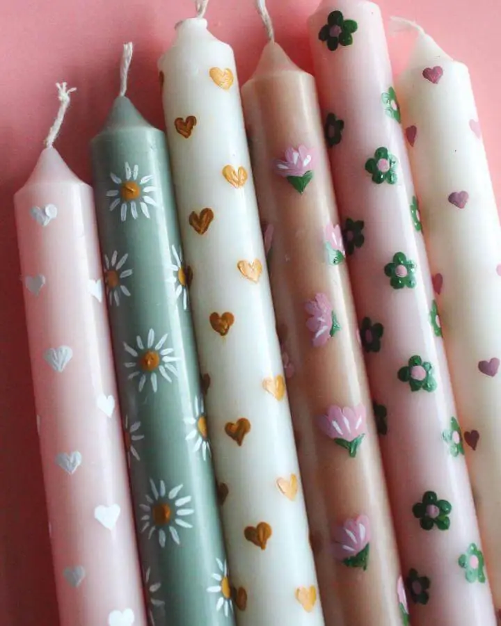 Hand-painted floral and heart candles from @prettylifegirls showcasing craft ideas for adults with pastel colors and decorative motifs.