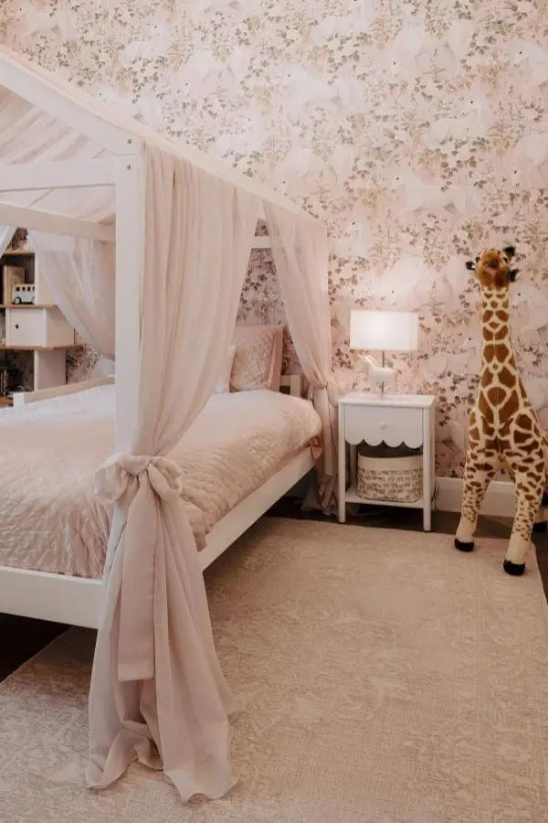 Playful giraffe accent piece in a cute pink bedroom from @craiglinke_. Whimsical and charming canopy oasis design.