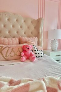 Whimsical pillows in a cute pink bedroom from @designedby_fran. Soft textures and playful patterns create delightful charm.