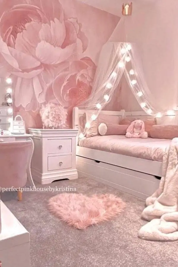 Fairy light canopy from @perfectpinkhousebykristina creates a dreamy ambiance in this whimsical, cute pink bedroom.