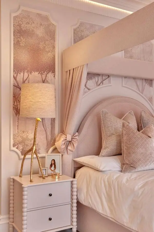 Whimsical giraffe lamp brightens space from @harriethughesinteriordesign, adding charm and playfulness to pink-themed nursery decor.