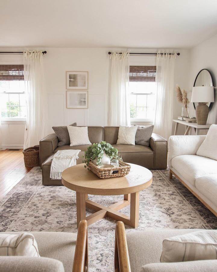 Dark brown leather couch in cozy neutral-toned living room with natural wood elements by @lizlovegrowswild.
