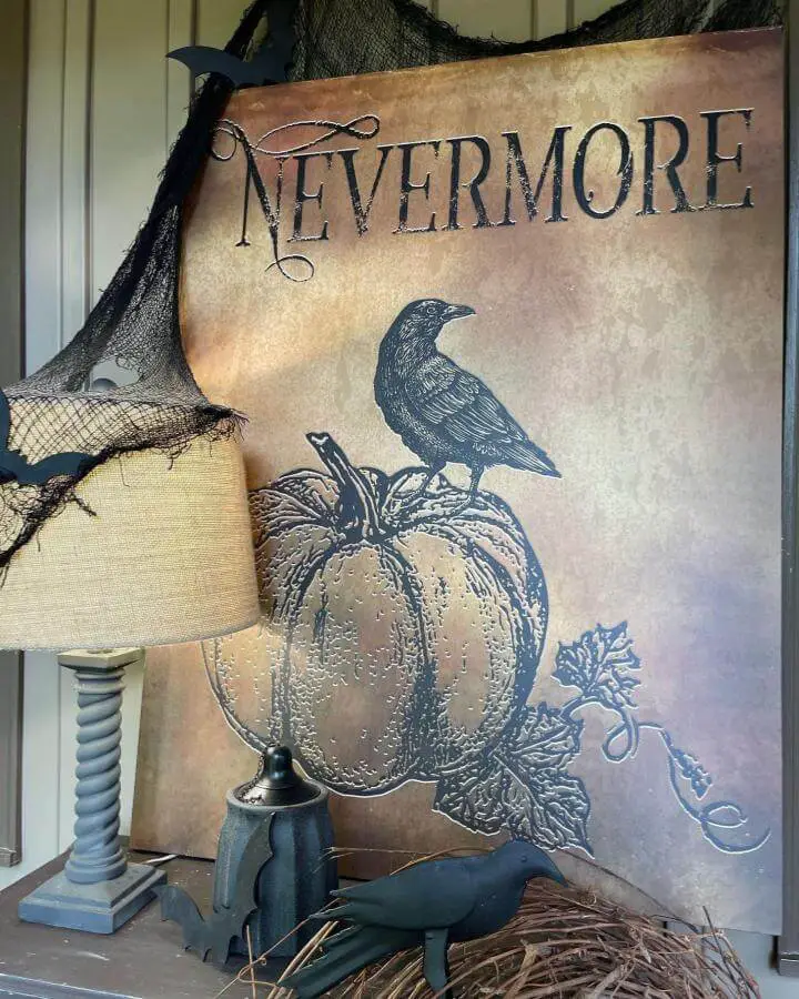 Vintage Nevermore wall art from @antiquefarmhouse featuring gothic typography, ravens, and autumn pumpkin illustrations with dramatic black cheesecloth draping.