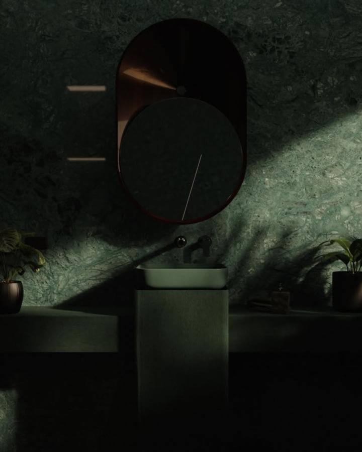 dark green powder room with textured marble walls and oval mirror from @claytan_official. Dramatic lighting and cozy design.