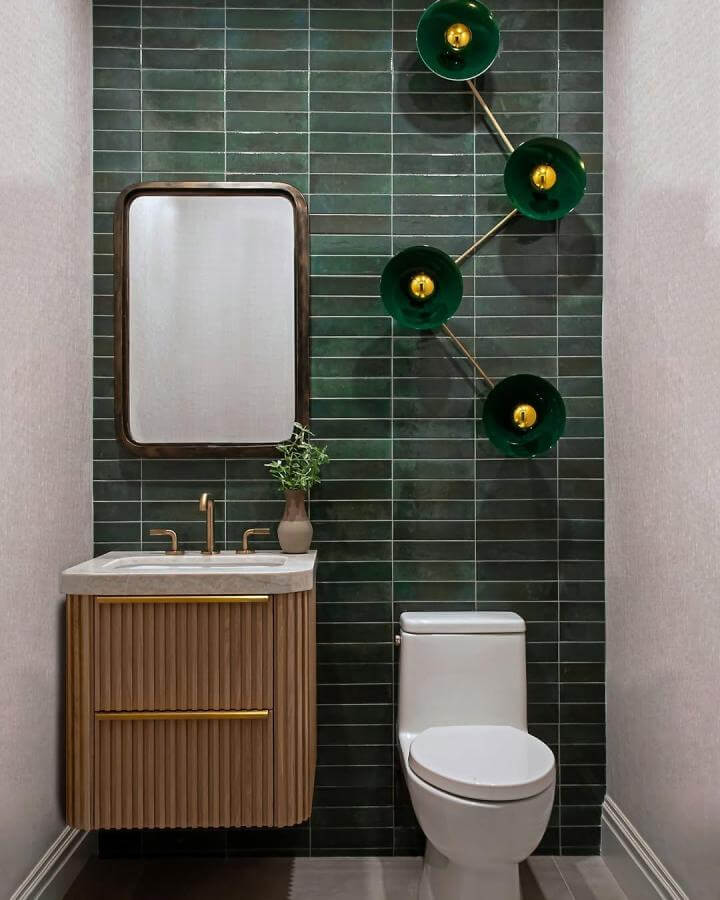 dark green rectangular tiled powder room wall with wood vanity and brass details from @linkinteriorsbylisatessler elegant and modern design