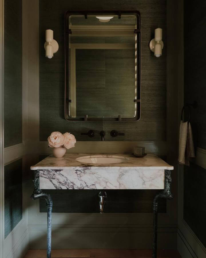 dark green powder room with marble vanity, matte black fixtures, and vintage metal legs by @william.jess.laird calm and elegant space