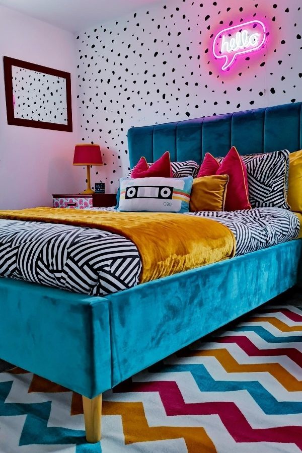 A lively teal bedroom with colorful decor and playful accents.