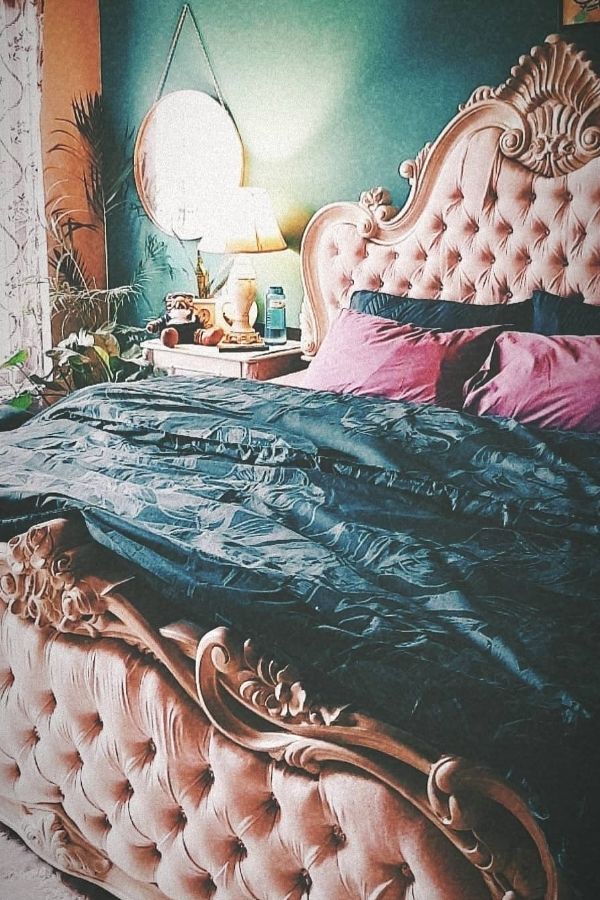 Ornate teal bed exudes vintage glamour with elegant, intricate details.