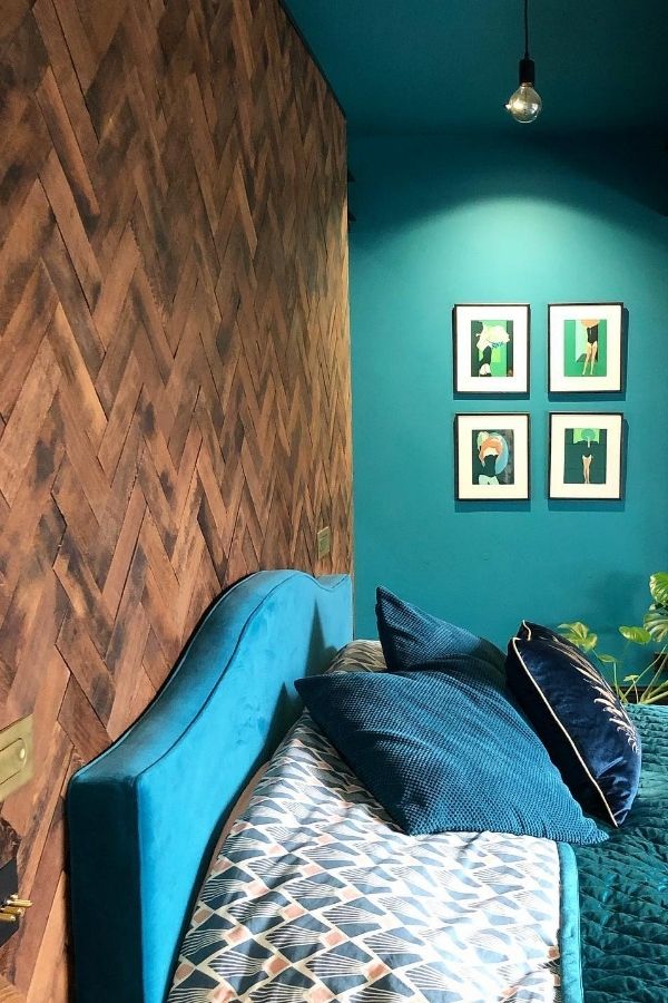 Teal accents complement wooden textures in a cozy rustic chic design.