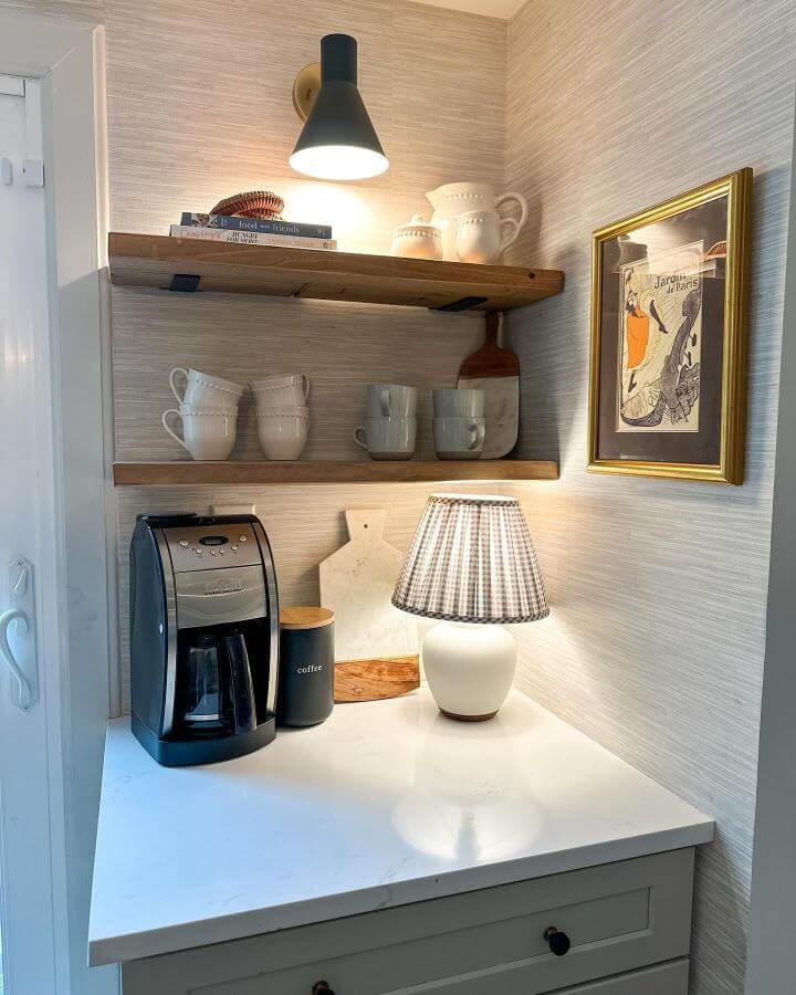 Warm wood shelves and white ceramics coffee nook by @harryhomeowner featuring soft lighting and clean lines for diy coffee bar ideas.