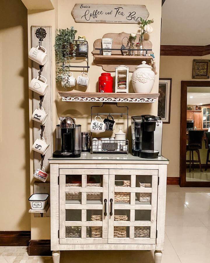 Neutral rustic coffee station with hanging mugs and vintage decor by @curatedsusie showcasing farmhouse style and cozy organization.