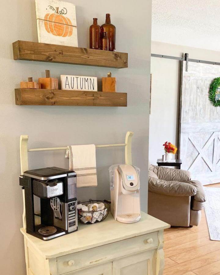Warm wooden floating shelves with autumn decor by @jenae_elizabeth5 perfect for cozy diy coffee bar ideas in kitchen corners.