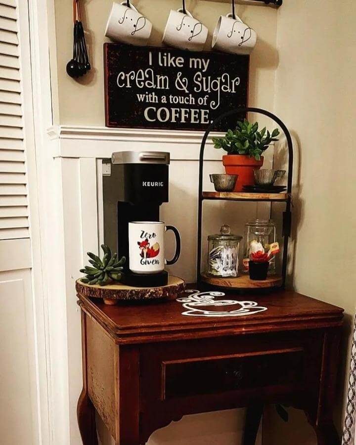 Rustic wooden coffee nook with metal shelf and potted plant by @love.to.be.meee featuring personal mug and hand-painted table art.
