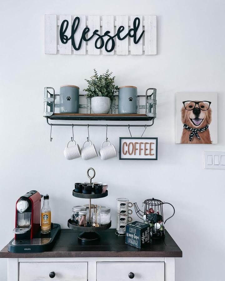 Gray ceramic canisters and hanging mugs on a rustic metal and wood shelf with farmhouse coffee decor by @diyyourdreamhome.