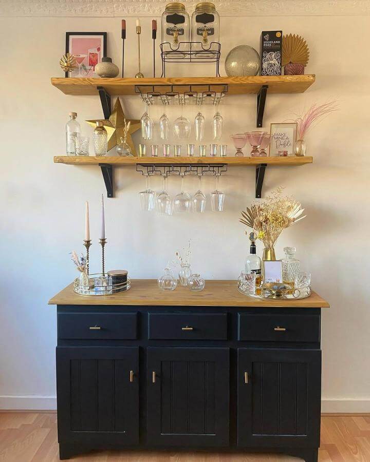 Black matte painted sideboard with wooden shelves and hanging glass racks diy drinks cabinet ideas by @homewithcatriona, cozy and stylish setup