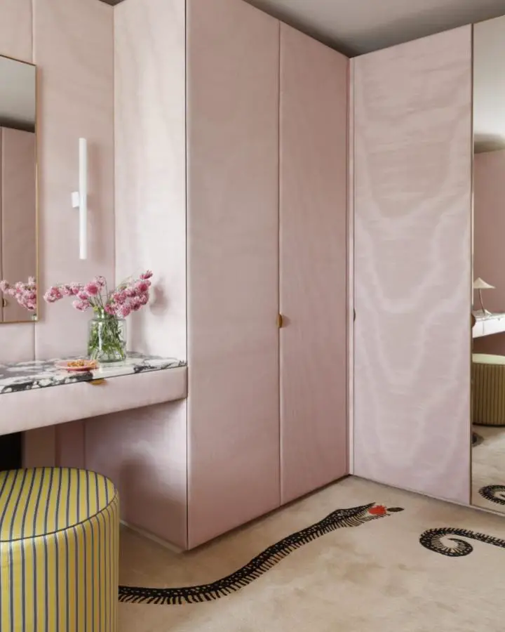 Blush pink built-in wardrobe system from @studioashby. Seamless storage with integrated vanity and marble countertop.