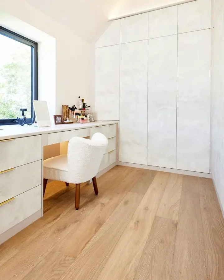 Sleek white fitted wardrobe system from @sharpsfittedfurniture with integrated vanity area and floor-to-ceiling storage.