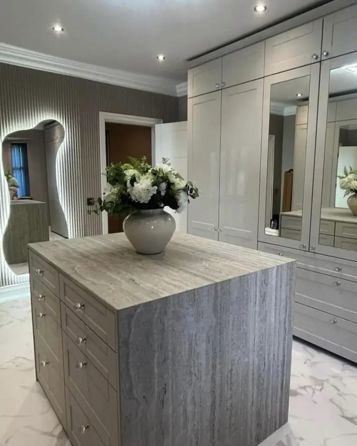 Marble island dressing room from @wrenkitchens featuring gray veined stone perfect for dream dressing room ideas.
