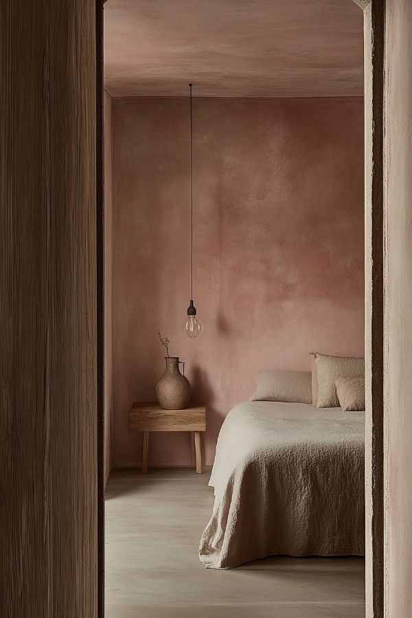 Warm minimalism with textured pink walls, cozy atmosphere, simple decor.