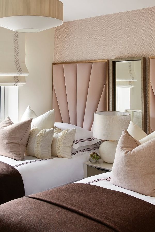 Modern twin beds with blush and brown tones in cozy room.