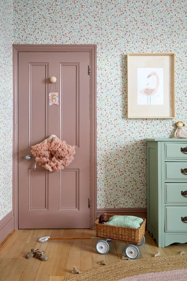 Whimsical pastel decor meets natural elements for charming rustic elegance.