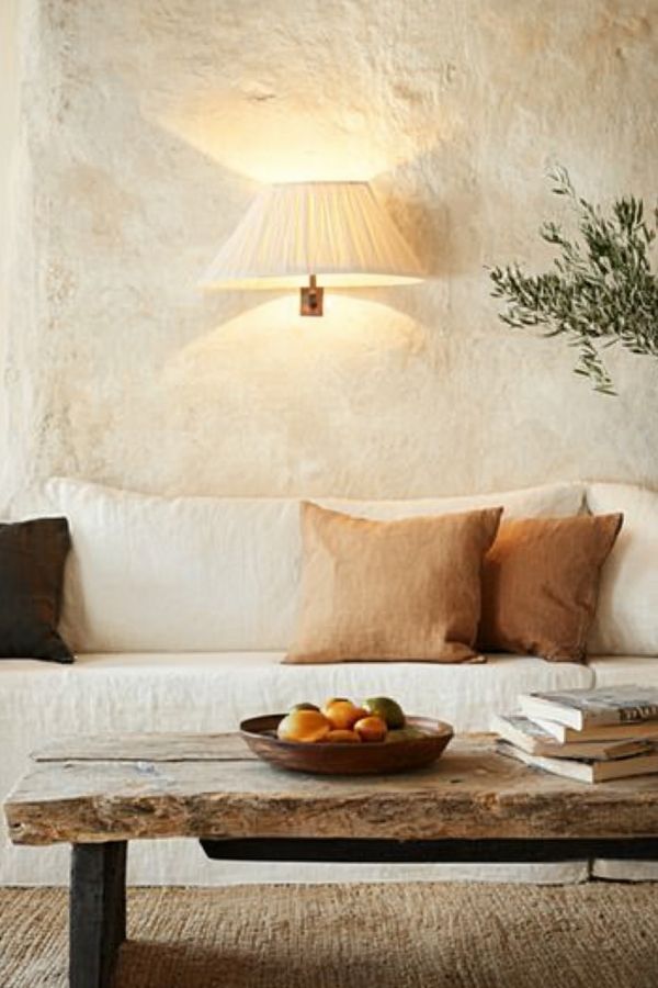 earthy living room with wooden furniture, green plants, and natural tones.