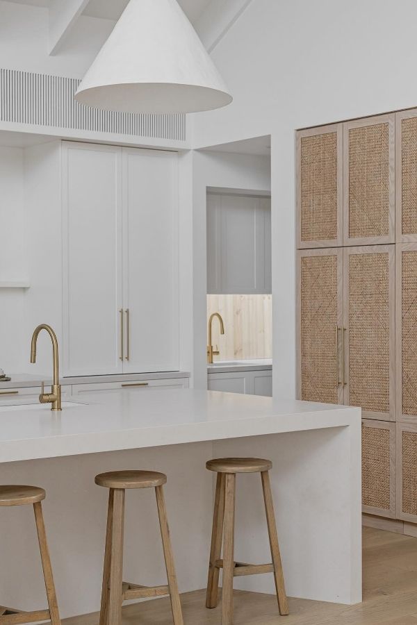 Neutral kitchen featuring woven cabinet details, minimalist design, and natural tones.