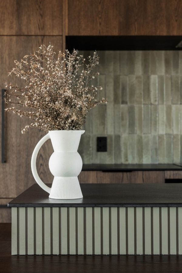 Modern kitchen featuring natural wood tones and minimalist design elements.