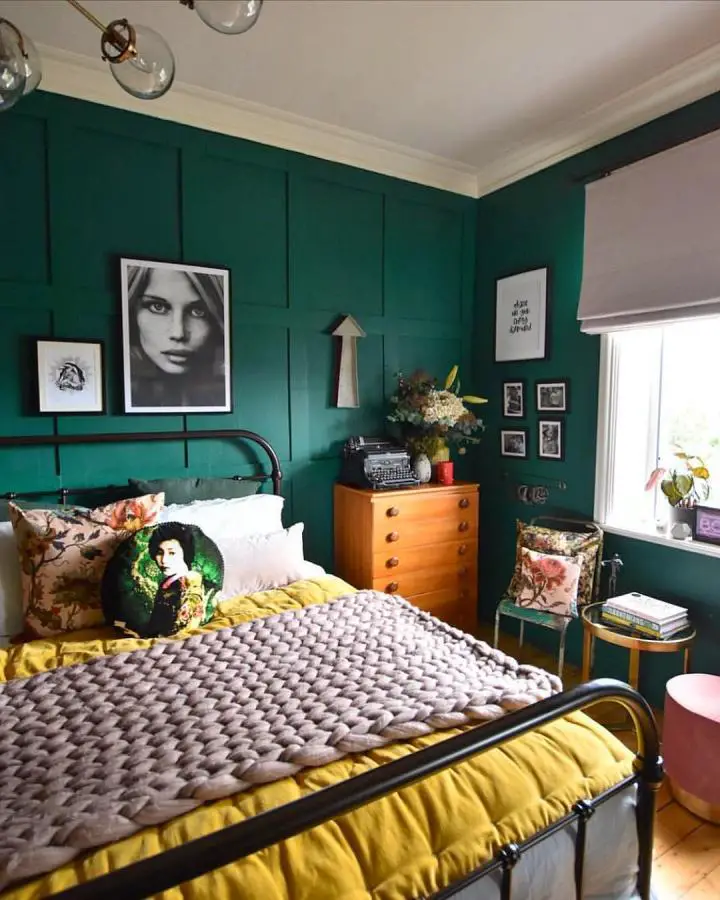 Emerald paneled bedroom from @the_girl_with_the_green_sofa. Mustard bedding and vintage furniture complete the look.