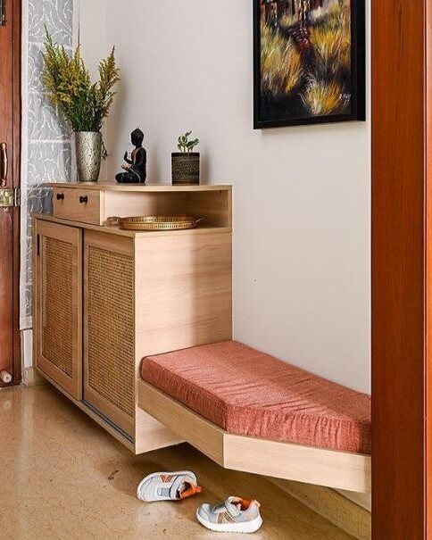 Light wood cane cabinet with terracotta cushioned bench entryway shoe storage ideas by @kinaayastudio, neat and stylish.