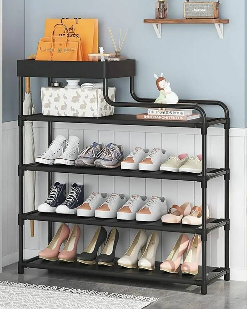Black metal multi-tier shoe rack from @grandezal_ in an entryway setting displaying various shoes for practical entryway shoe storage ideas.